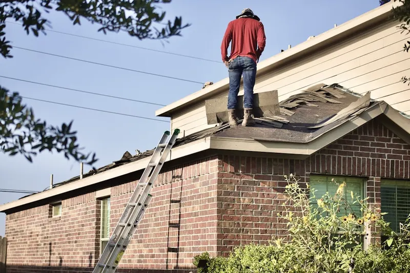 Professional roofer working on a residential roof in Waterstone